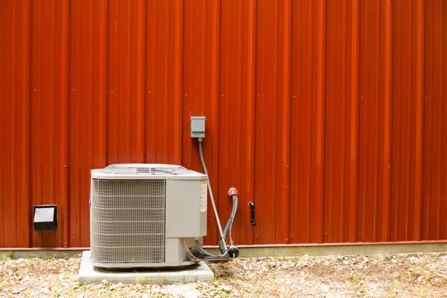 Residential AC condenser unit outside a home in Forney, TX
